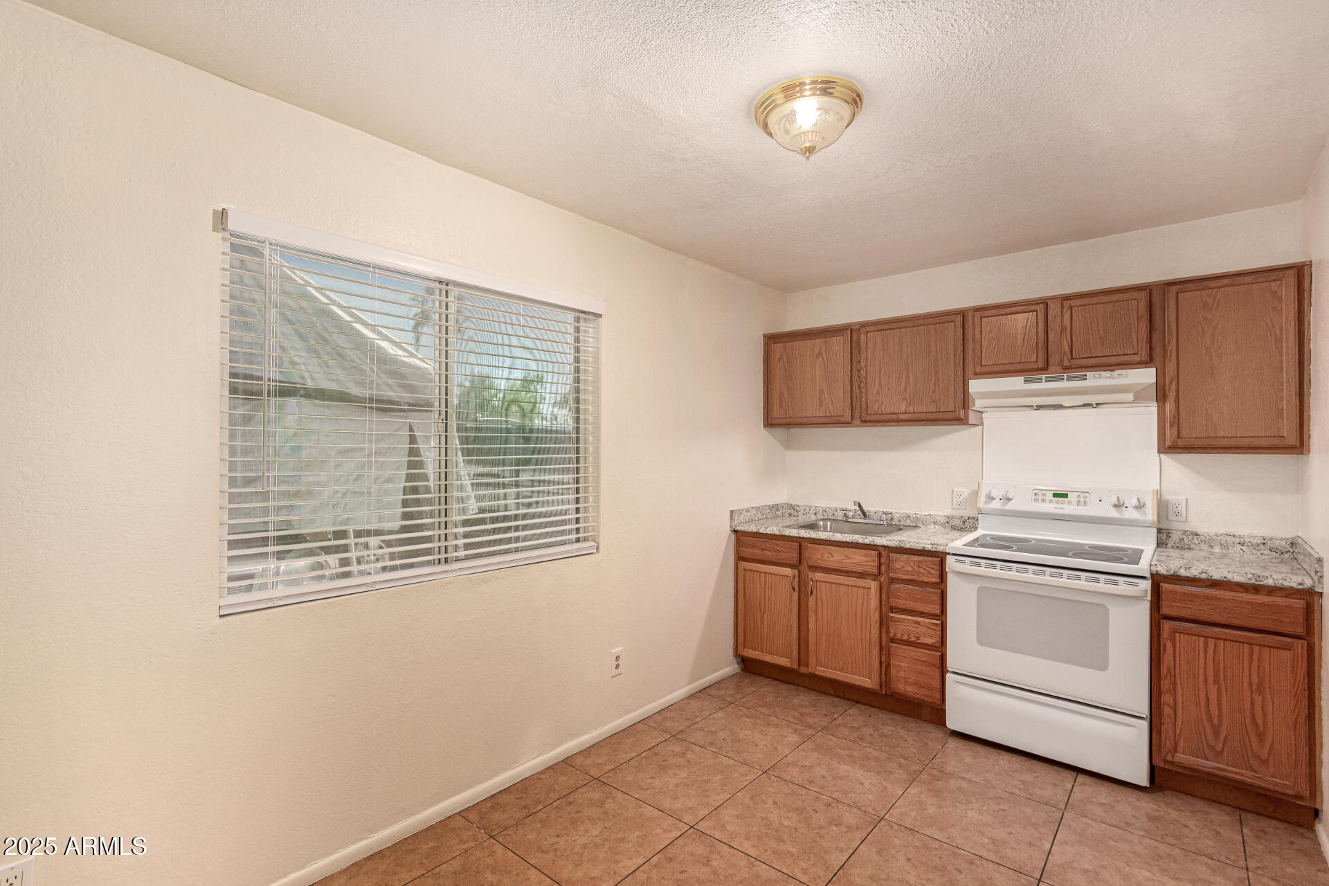 1318 East Culver Street, Unit 1 Phoenix, AZ 85006 - Photo 5 of 26 a kitchen with stainless steel appliances granite countertop a stove and a sink