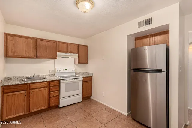 a kitchen with stainless steel appliances granite countertop a stove and a sink