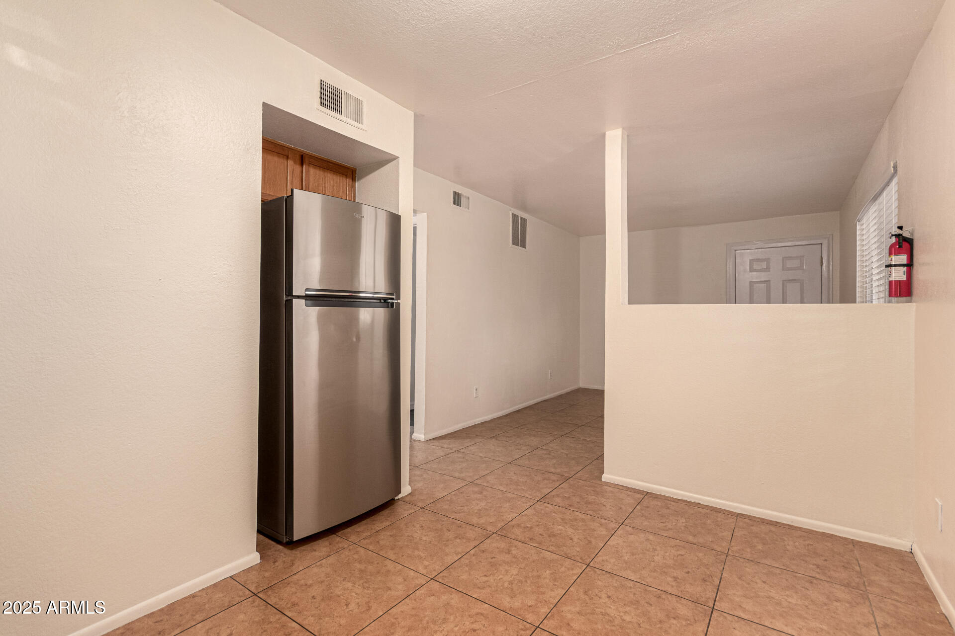 1318 East Culver Street, Unit 1 Phoenix, AZ 85006 - Photo 7 of 26 a view of a kitchen with a refrigerator and a microwave