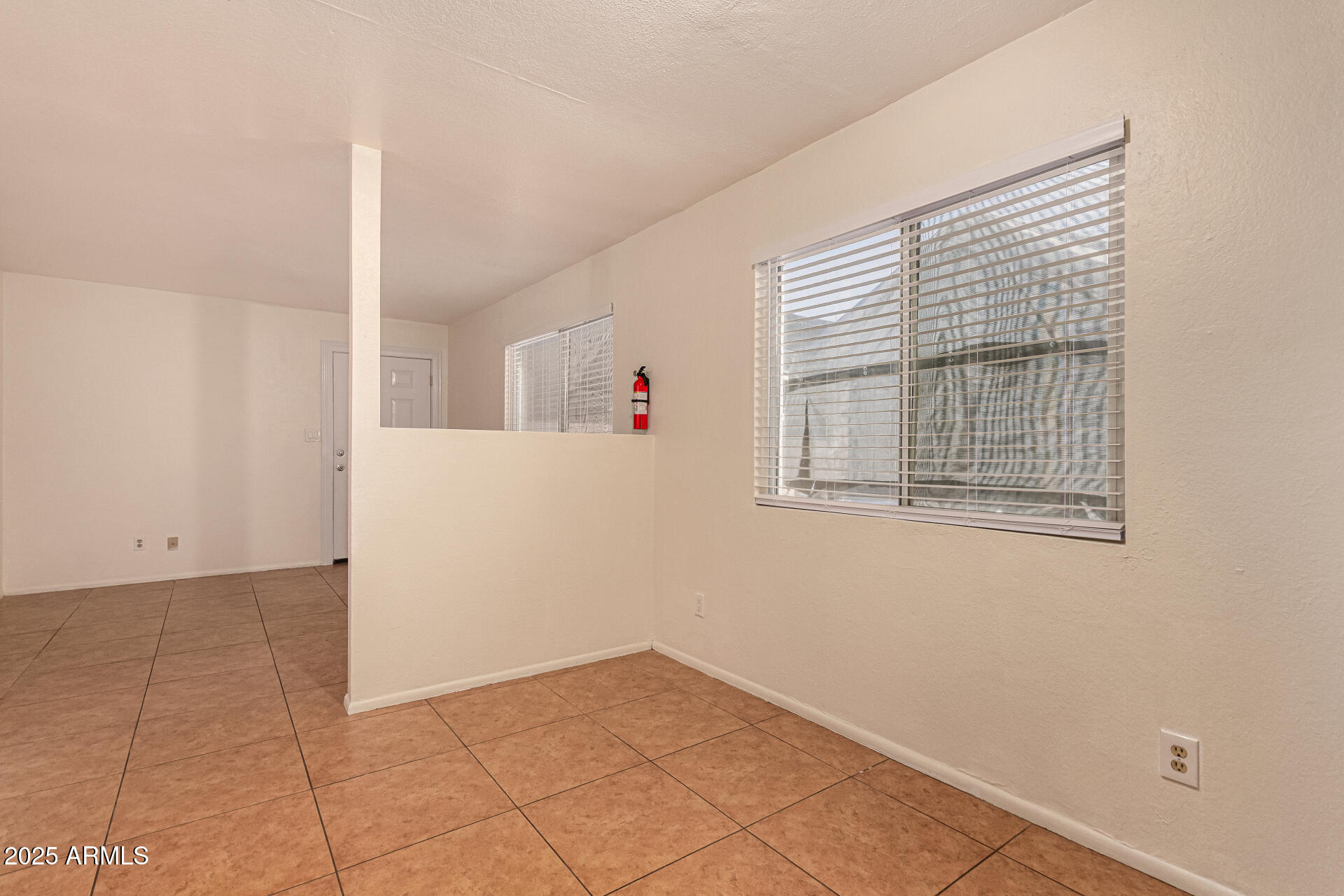 1318 East Culver Street, Unit 1 Phoenix, AZ 85006 - Photo 8 of 26 a view of an empty room with windows