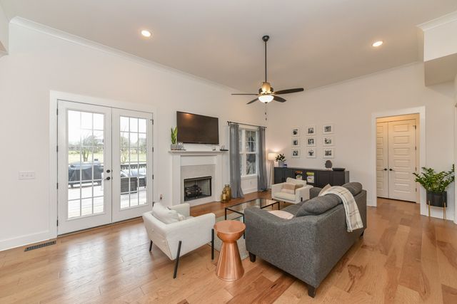 a kitchen with stainless steel appliances kitchen island granite countertop a sink a stove a refrigerator and island with wooden floor