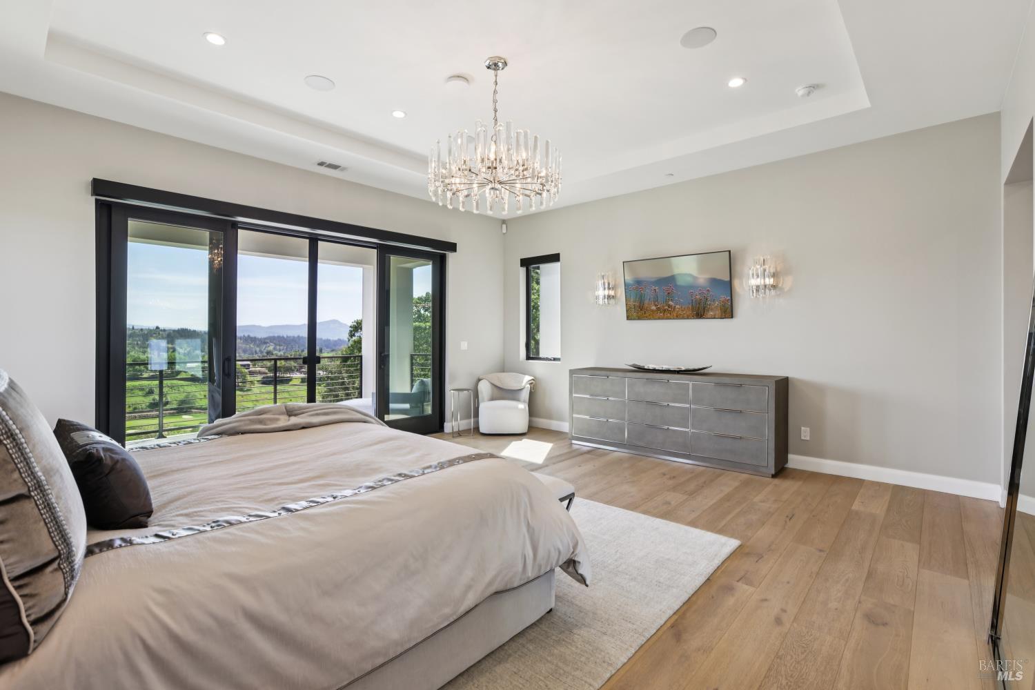 3758 Skyfarm Drive Santa Rosa, CA 95403 - Photo 33 of 80 a spacious bedroom with a bed and a chandelier