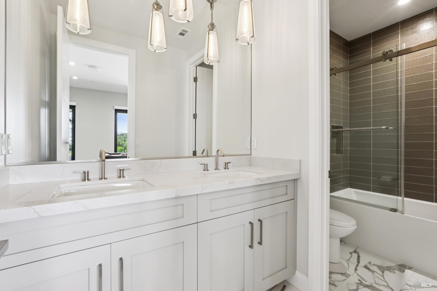 3758 Skyfarm Drive Santa Rosa, CA 95403 - Photo 52 of 80 a bathroom with a granite countertop sink a toilet a mirror and shower