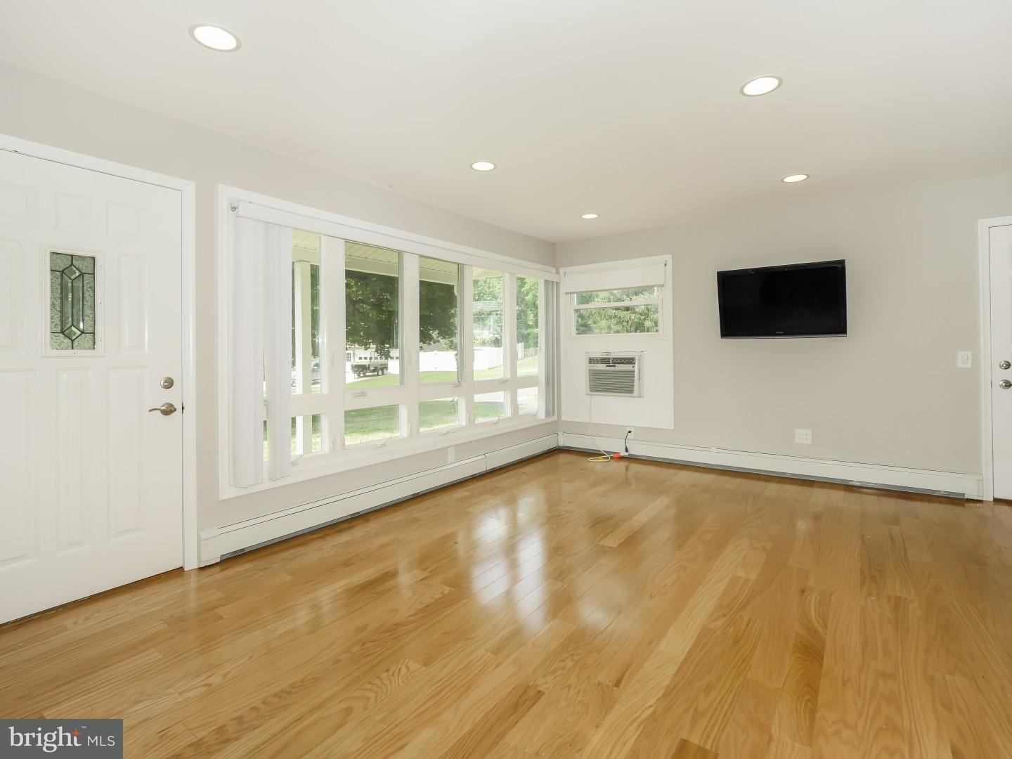 15 St Dunstans Road Hatboro, PA 19040 - Photo 3 of 25 a view of an empty room with wooden floor and a window