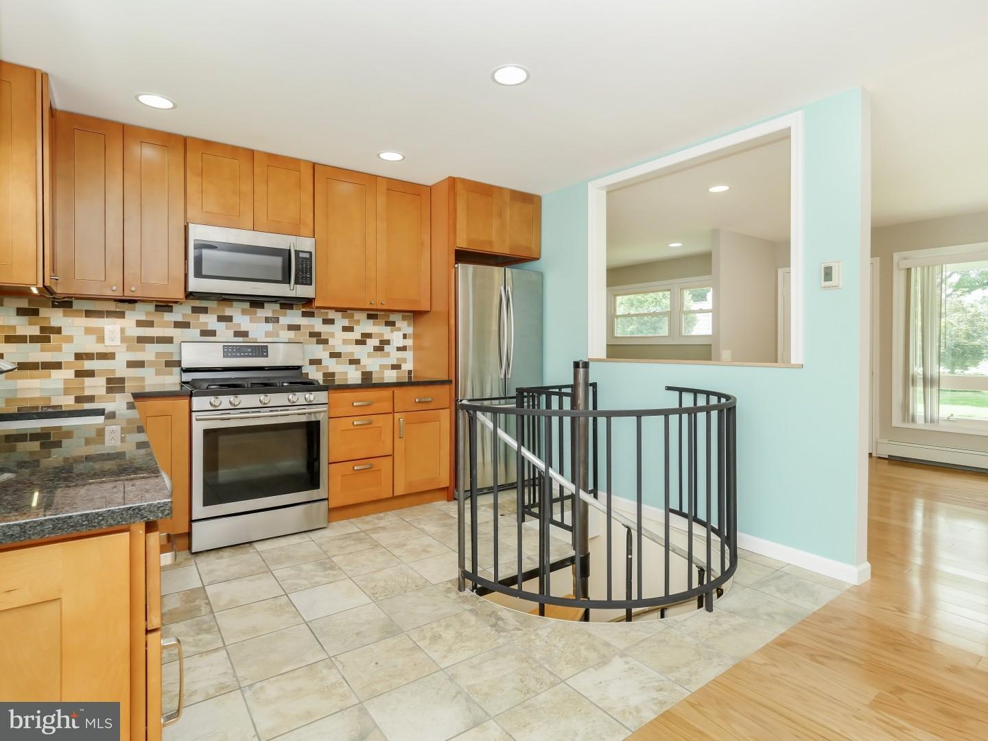 15 St Dunstans Road Hatboro, PA 19040 - Photo 6 of 25 a kitchen with stainless steel appliances granite countertop a stove a sink and a refrigerator
