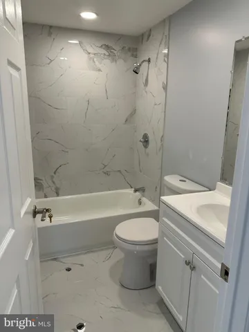 a bathroom with a sink a toilet and a bathtub