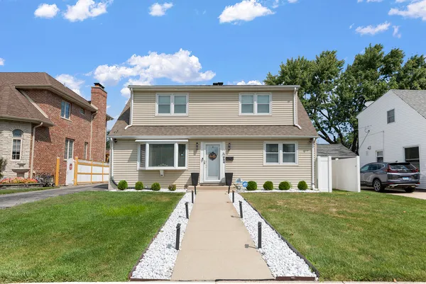a front view of a house with a garden and patio