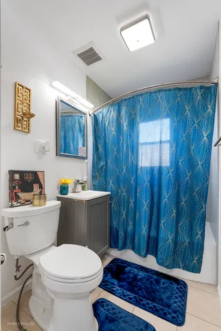 a bathroom with a toilet a sink and a shower