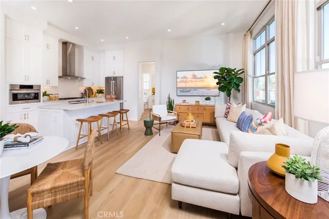 a living room with furniture kitchen and a large window