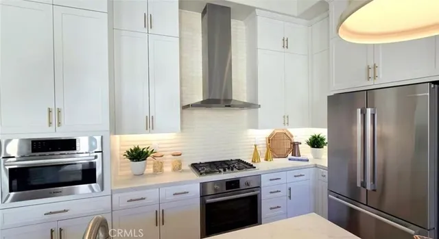 a kitchen with cabinets stainless steel appliances and a counter space