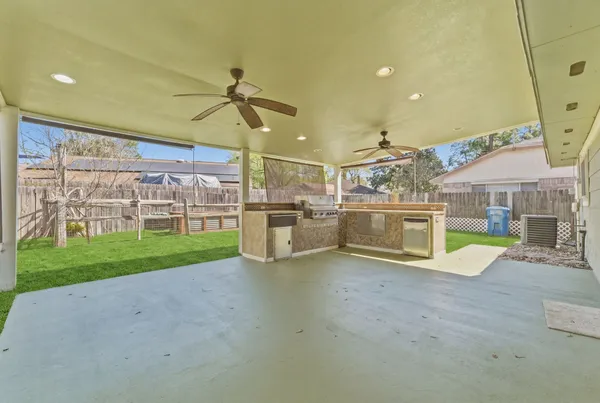 a view of a house with a backyard and a patio