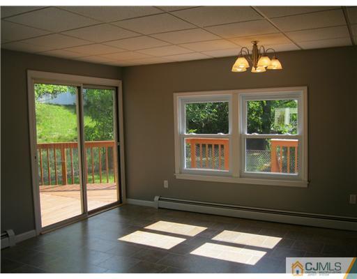 78 Brandywine Road Fords, NJ 08863 - Photo 11 of 13 a view of an empty room with wooden floor and a window