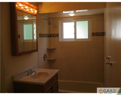 78 Brandywine Road Fords, NJ 08863 - Photo 13 of 13 a bathroom with a sink and a mirror