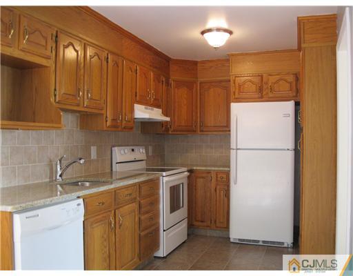 78 Brandywine Road Fords, NJ 08863 - Photo 10 of 13 a kitchen with stainless steel appliances granite countertop a refrigerator a sink a stove and white cabinets