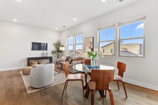a dining room with furniture and wooden floor