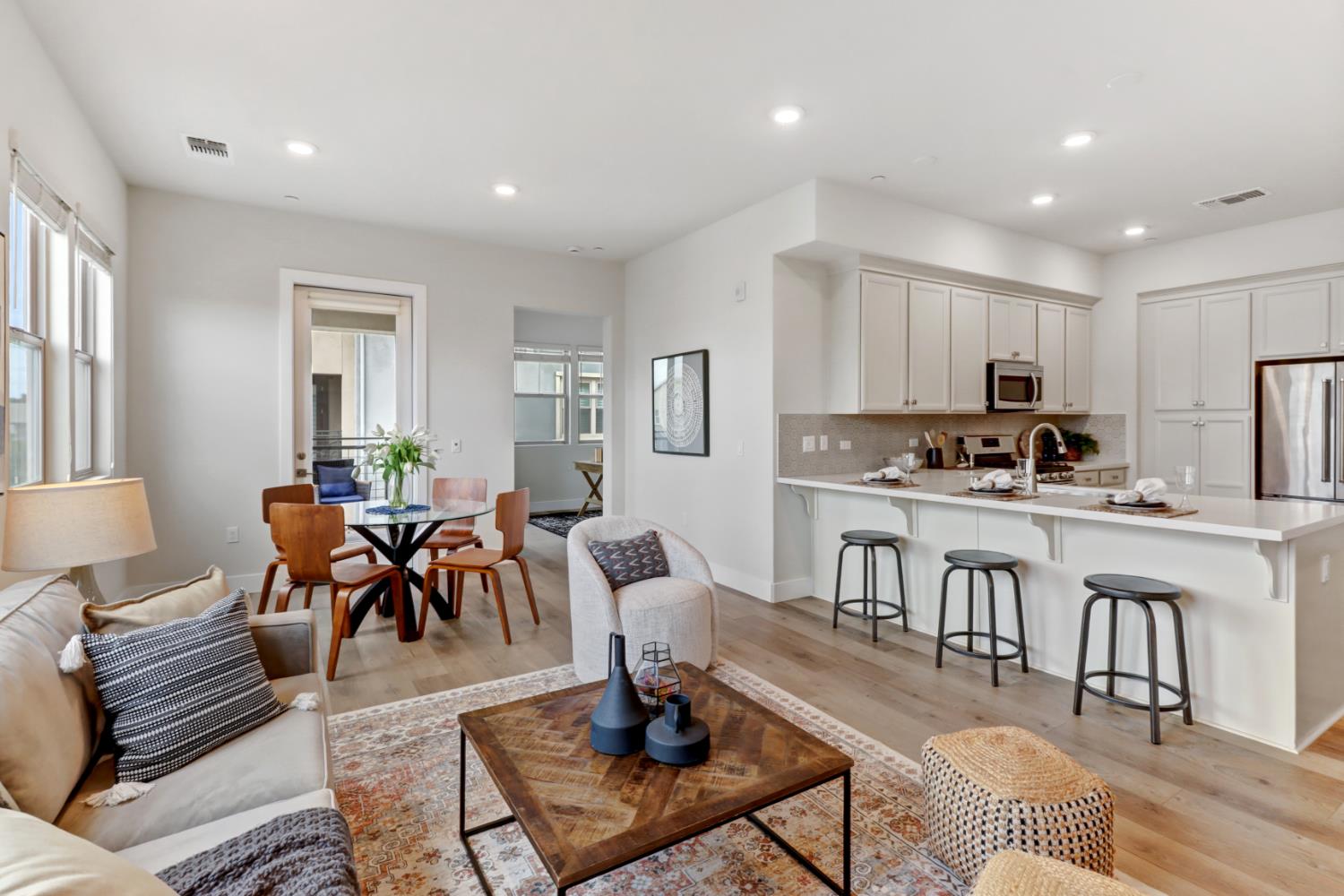 1661 Spring Street, Unit 343 Davis, CA 95616 - Photo 16 of 52 a living room with lots of furniture and kitchen view