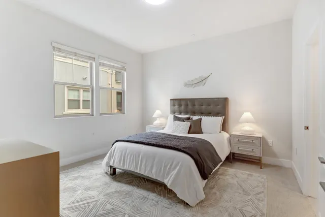 a bedroom with a bed and a night stand