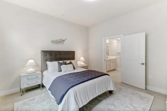 a bedroom with bed and a night stand