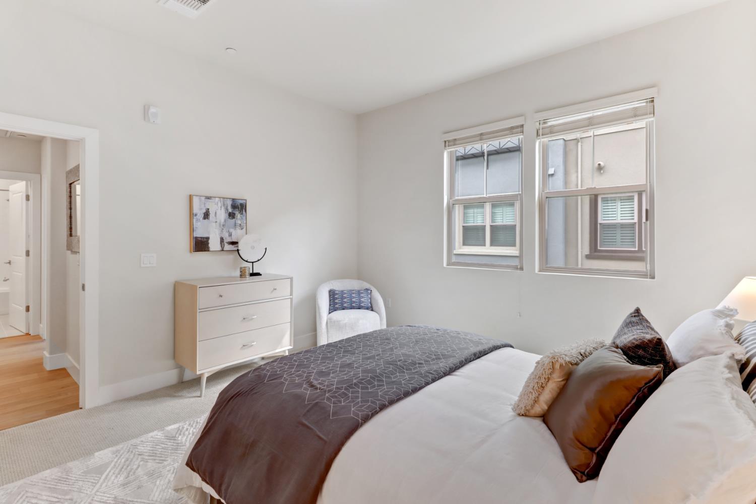 1661 Spring Street, Unit 343 Davis, CA 95616 - Photo 20 of 52 a bedroom with a bed and wooden floor