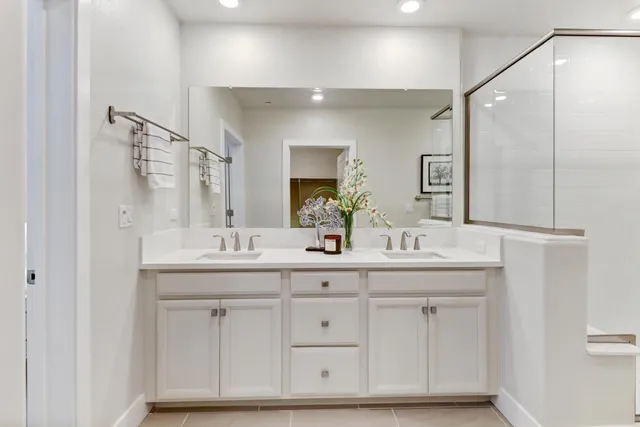 a bathroom with a double vanity sink and mirror