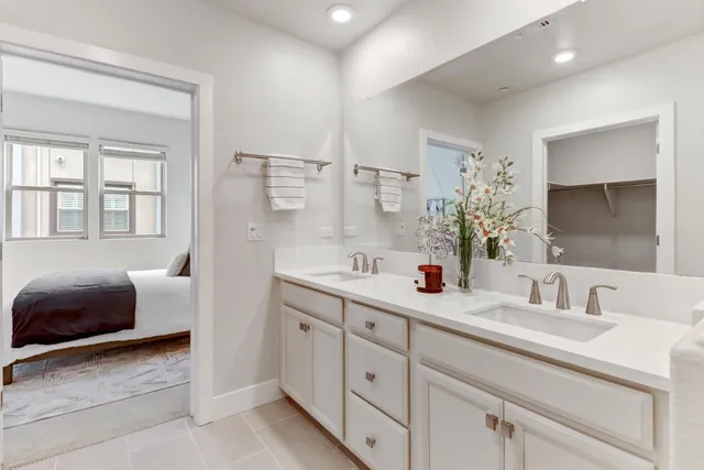 a en suite bathroom with double sink and a mirror