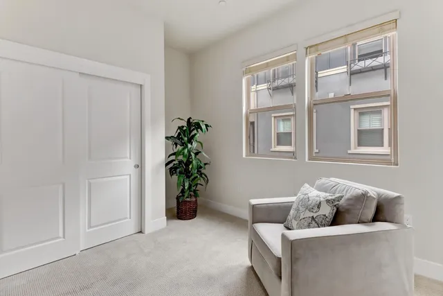 a living room with furniture and flowers