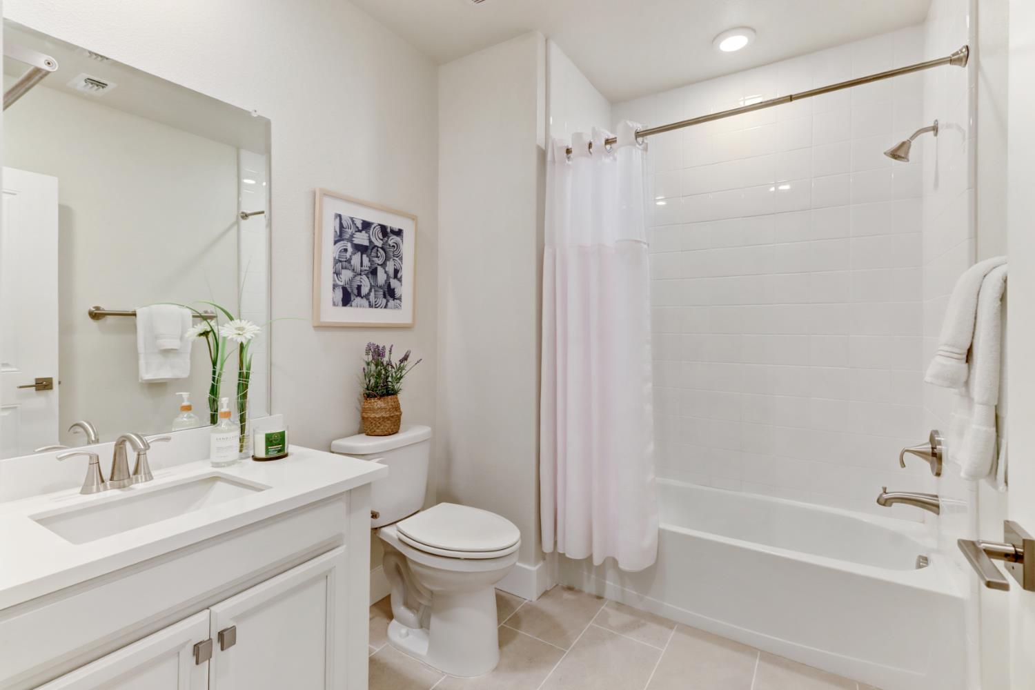 1661 Spring Street, Unit 343 Davis, CA 95616 - Photo 29 of 52 a bathroom with a sink a toilet and shower