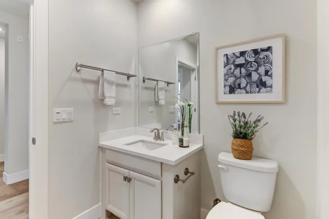 a bathroom with a sink mirror and toilet