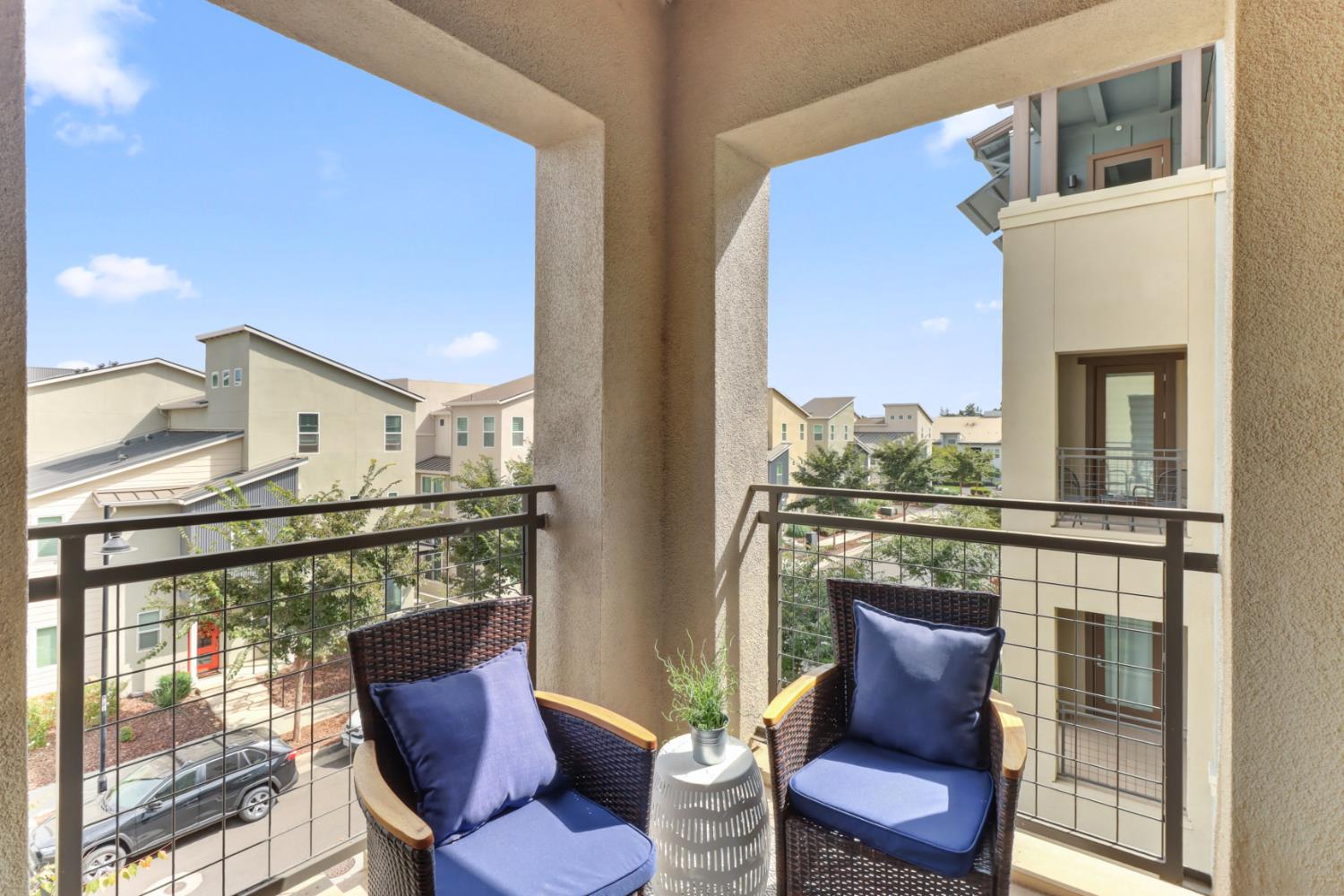 1661 Spring Street, Unit 343 Davis, CA 95616 - Photo 32 of 52 a balcony view with couple of chairs and wooden floor