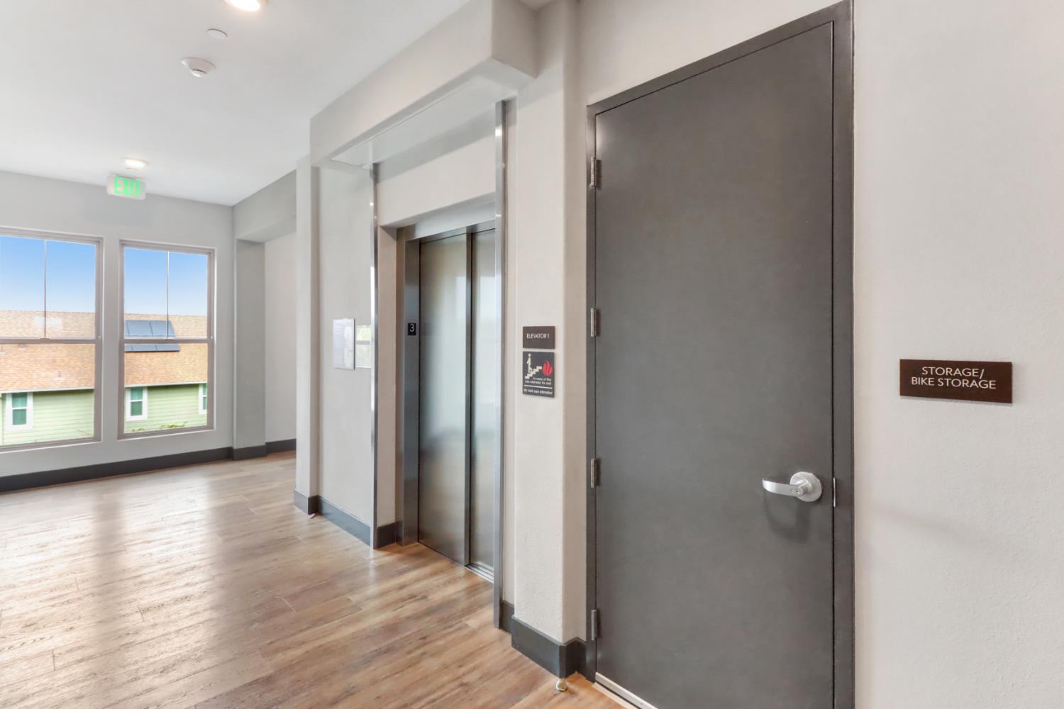 1661 Spring Street, Unit 343 Davis, CA 95616 - Photo 40 of 52 a view of a hallway with wooden floor and windows
