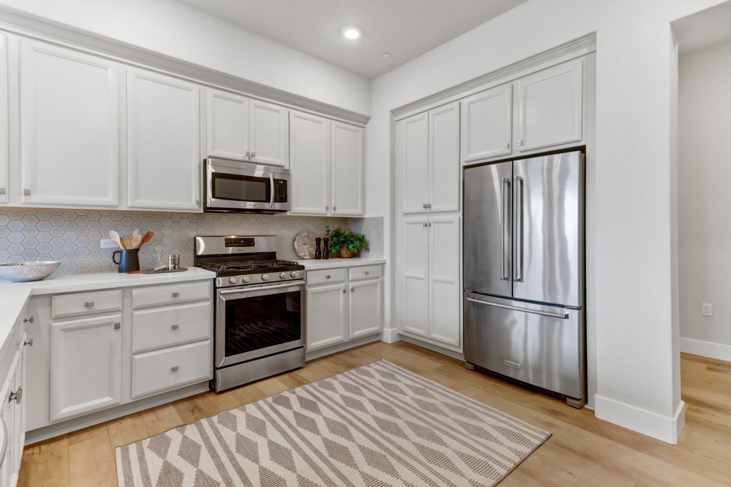 1661 Spring Street, Unit 343 Davis, CA 95616 - Photo 4 of 52 a kitchen with cabinets stainless steel appliances and a window