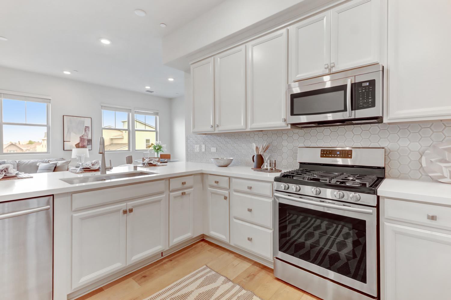 1661 Spring Street, Unit 343 Davis, CA 95616 - Photo 5 of 52 a kitchen with stainless steel appliances granite countertop a stove a sink and a microwave