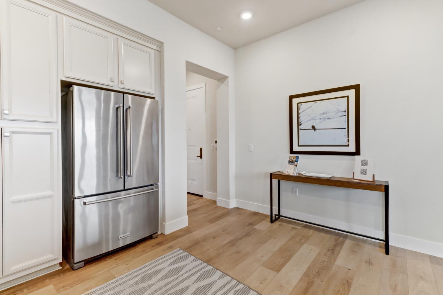 1661 Spring Street, Unit 343 Davis, CA 95616 - Photo 6 of 52 a view of a livingroom with wooden floor and a refrigerator