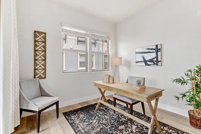 a dining room with furniture and wooden floor