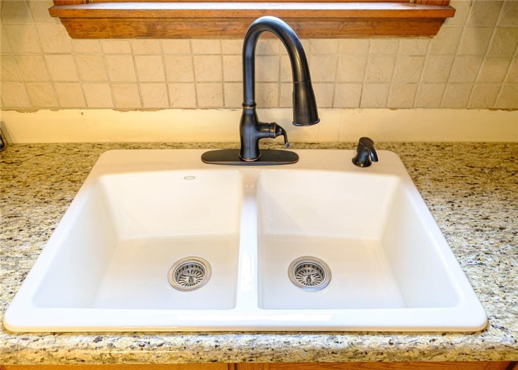 3121 Conway Wallrose Road Baden, PA 15005 - Photo 7 of 25 a bathroom with a granite countertop sink and a vanity