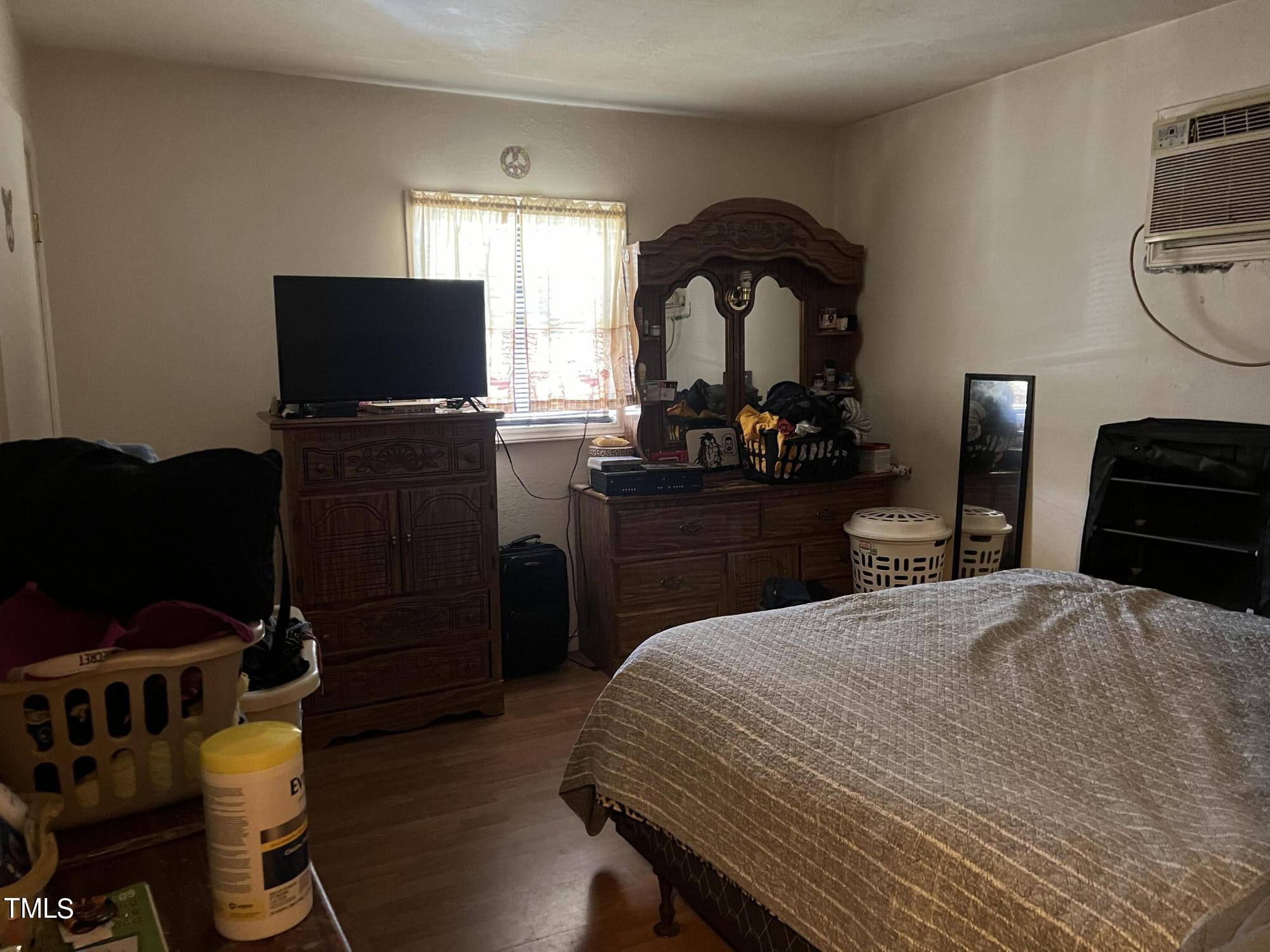 626 Middle Street Durham, NC 27703 - Photo 11 of 42 a bedroom with a bed and a television