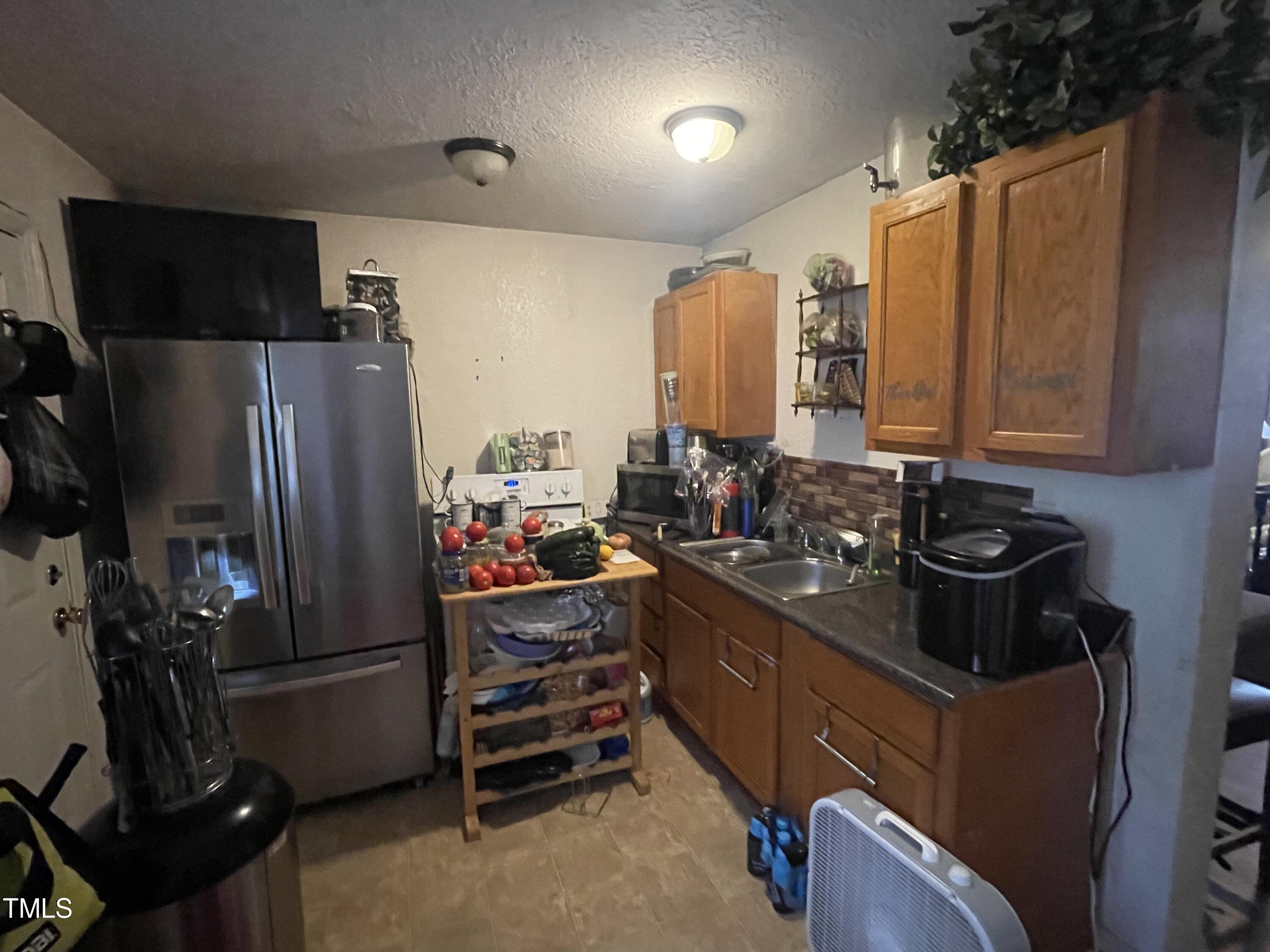 626 Middle Street Durham, NC 27703 - Photo 21 of 42 a kitchen with refrigerator and cabinets