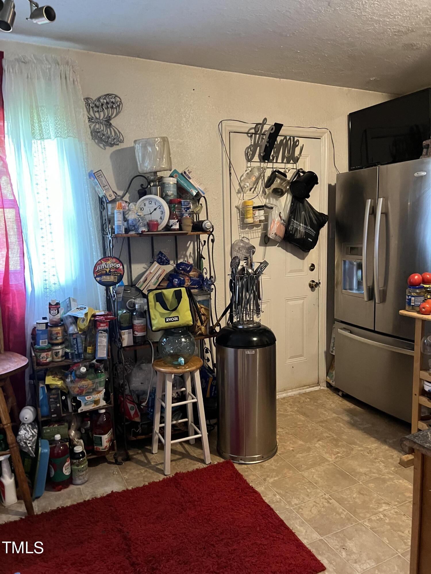 626 Middle Street Durham, NC 27703 - Photo 22 of 42 a room with lots of different colored cloths
