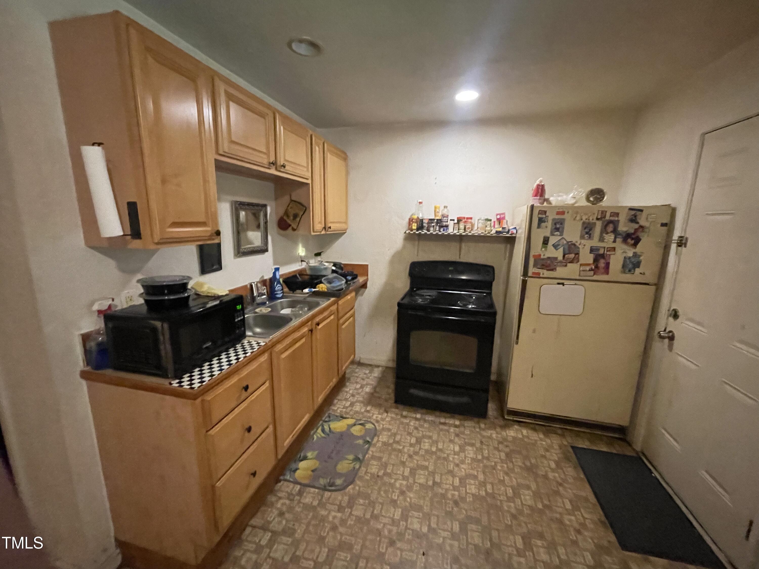 626 Middle Street Durham, NC 27703 - Photo 7 of 42 a kitchen with stainless steel appliances granite countertop a refrigerator a stove a sink and a microwave