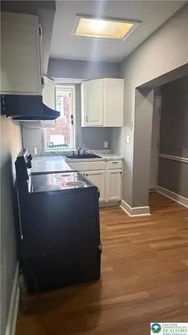 a view of room with window and wooden floor