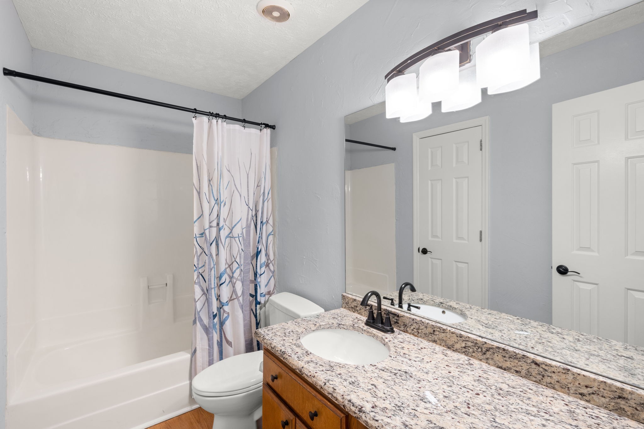 129 Thistle Lane Hermitage, TN 37076 - Photo 15 of 22 a bathroom with a granite countertop sink and a mirror