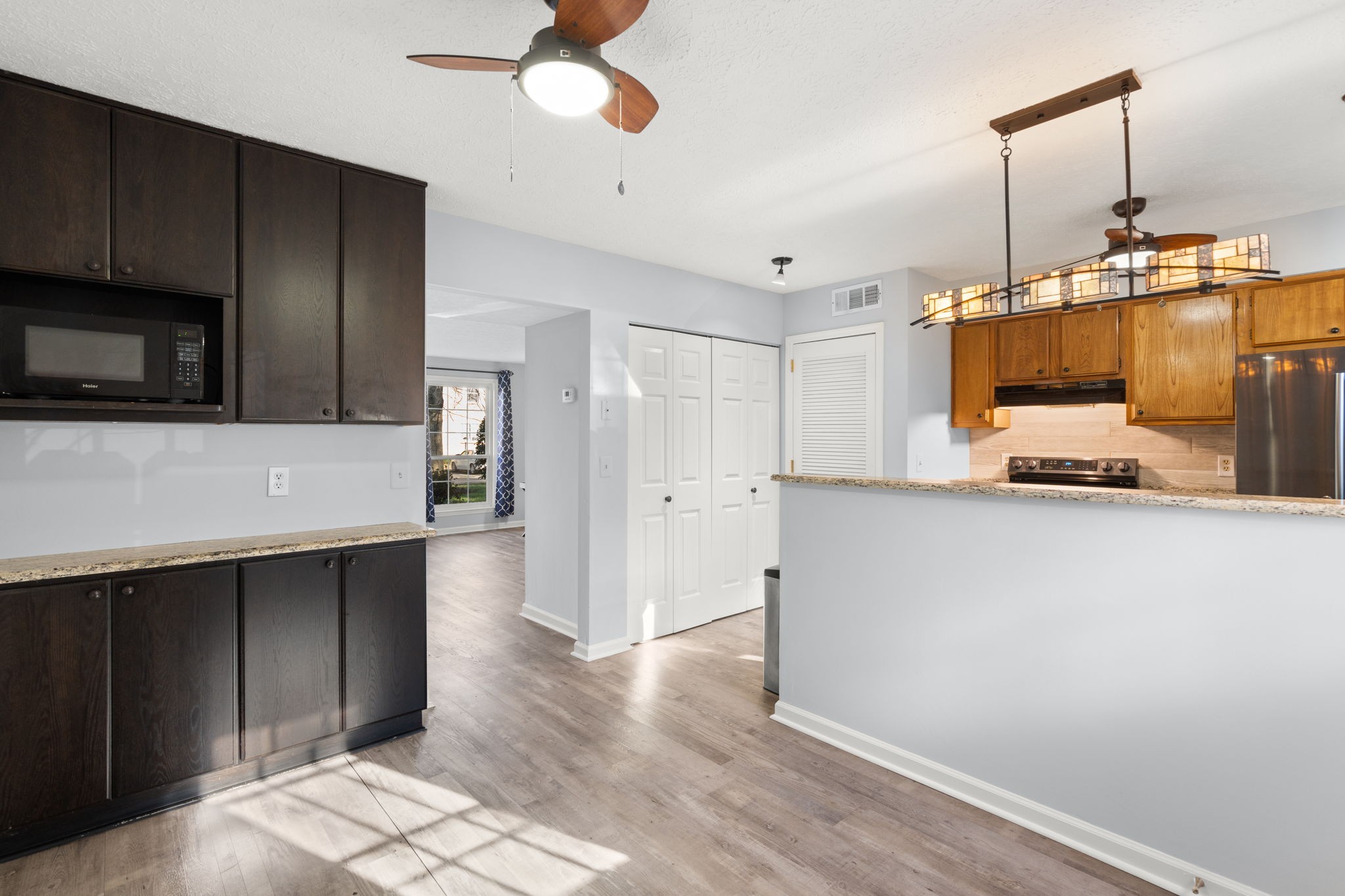 129 Thistle Lane Hermitage, TN 37076 - Photo 10 of 22 a kitchen with kitchen island white cabinets and stainless steel appliances