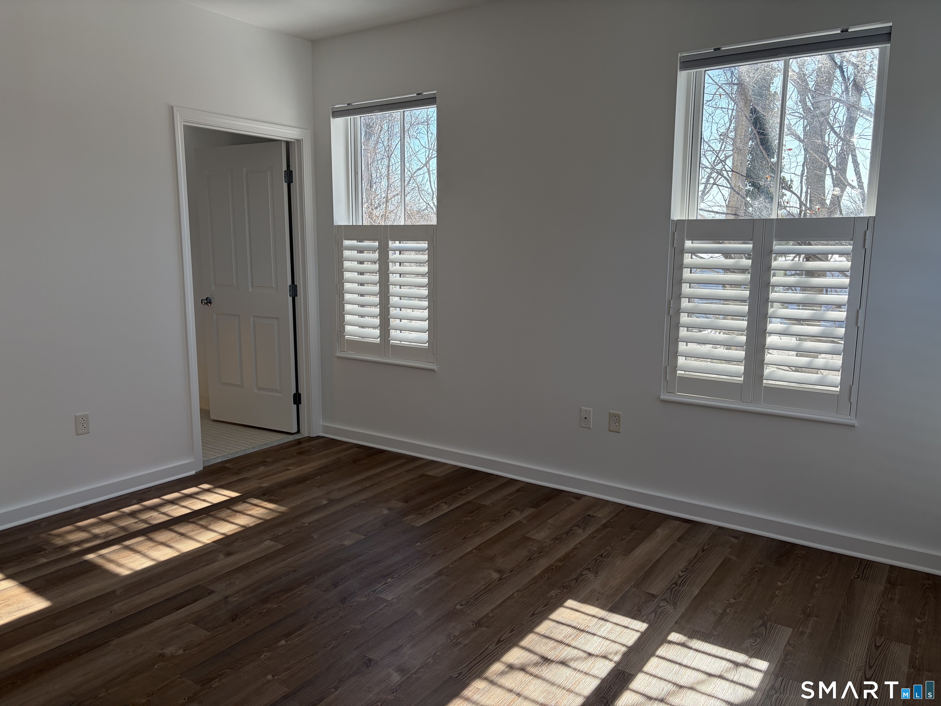 22 Durham Road, Unit A2 Madison, CT 06443 - Photo 13 of 22 a view of an empty room with wooden floor and a window