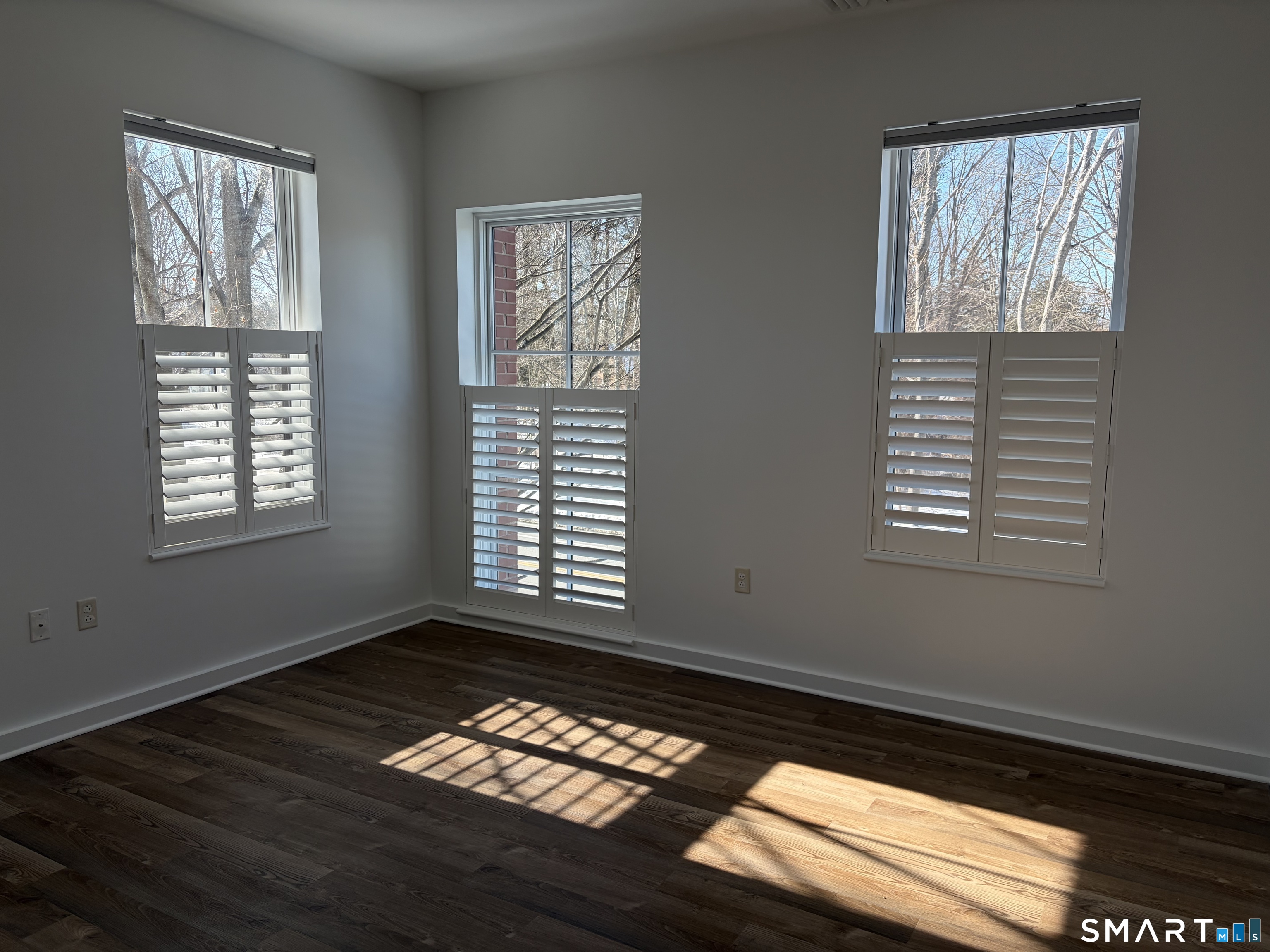 22 Durham Road, Unit A2 Madison, CT 06443 - Photo 20 of 22 a view of an empty room with wooden floor and a window