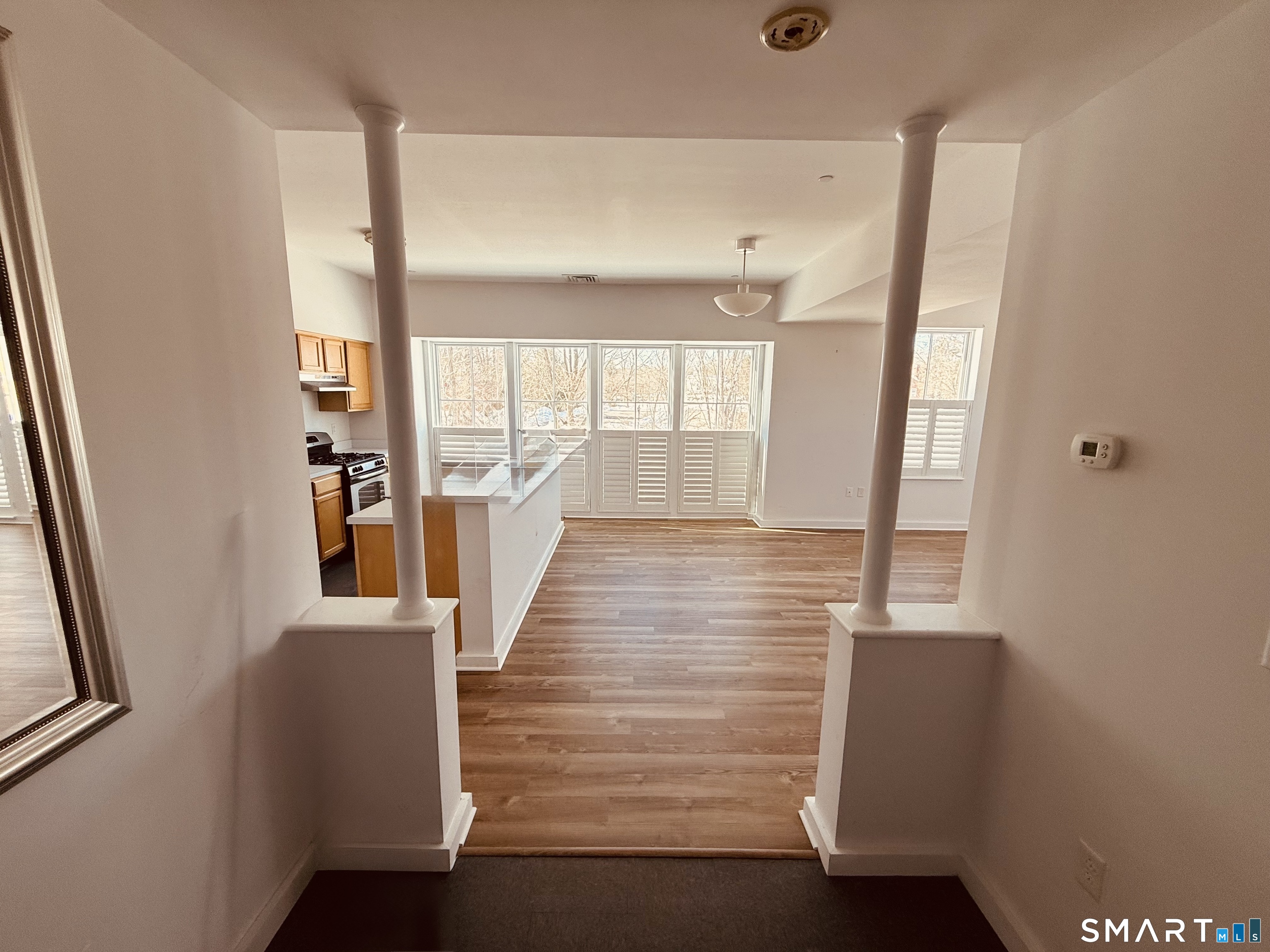 22 Durham Road, Unit A2 Madison, CT 06443 - Photo 2 of 22 a view of a hallway with wooden floor and staircase