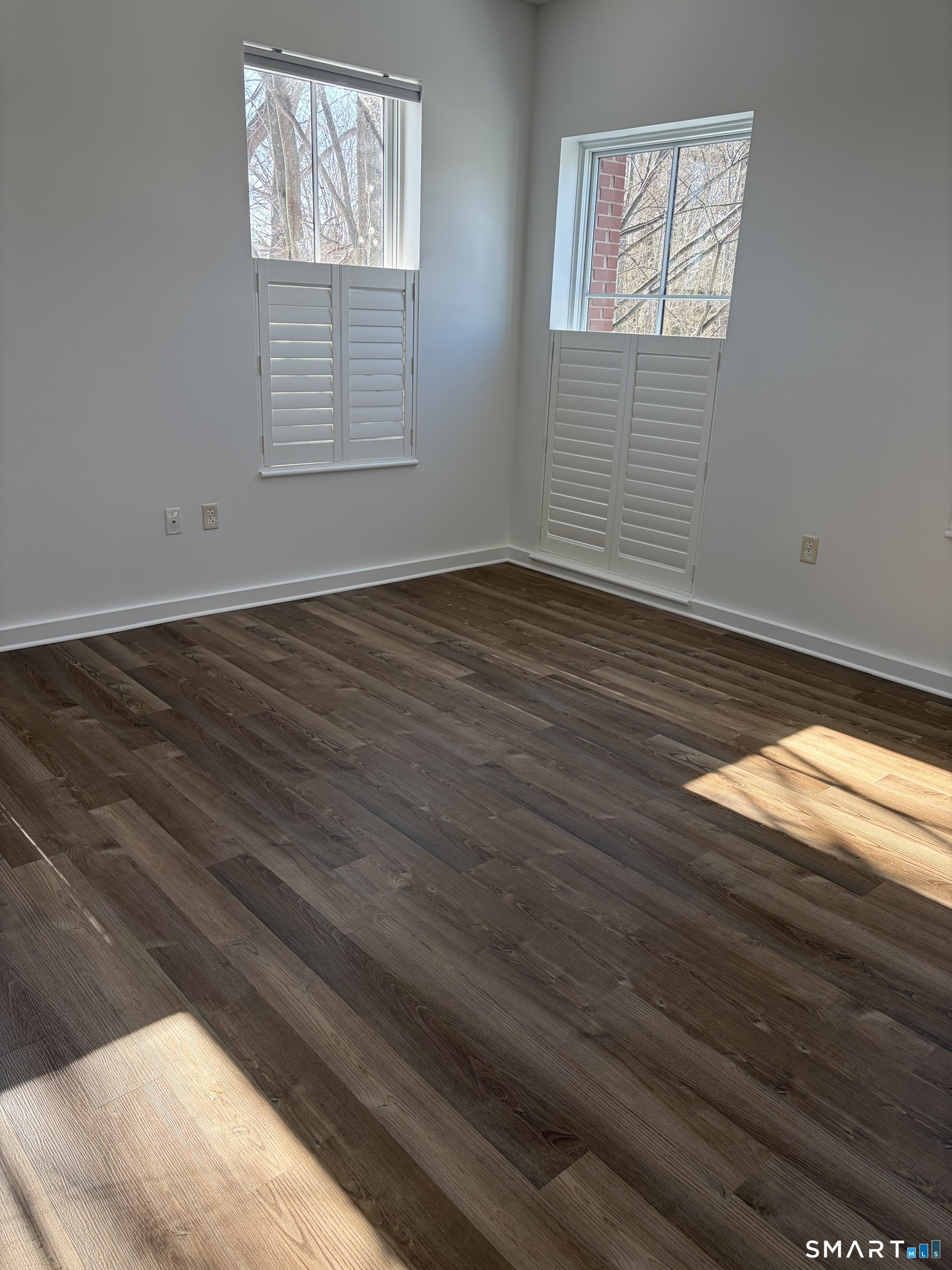 22 Durham Road, Unit A2 Madison, CT 06443 - Photo 21 of 22 a view of an empty room with wooden floor and a window
