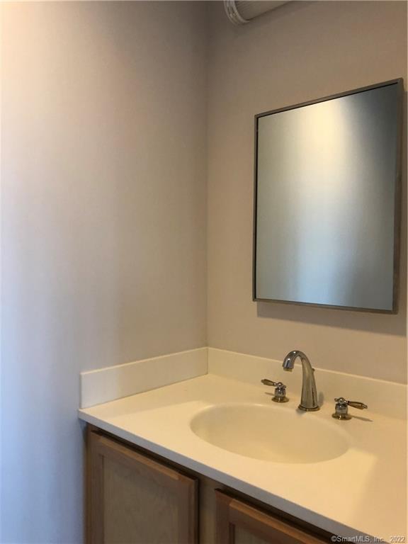 22 Durham Road, Unit A2 Madison, CT 06443 - Photo 3 of 22 a bathroom with a sink and a mirror