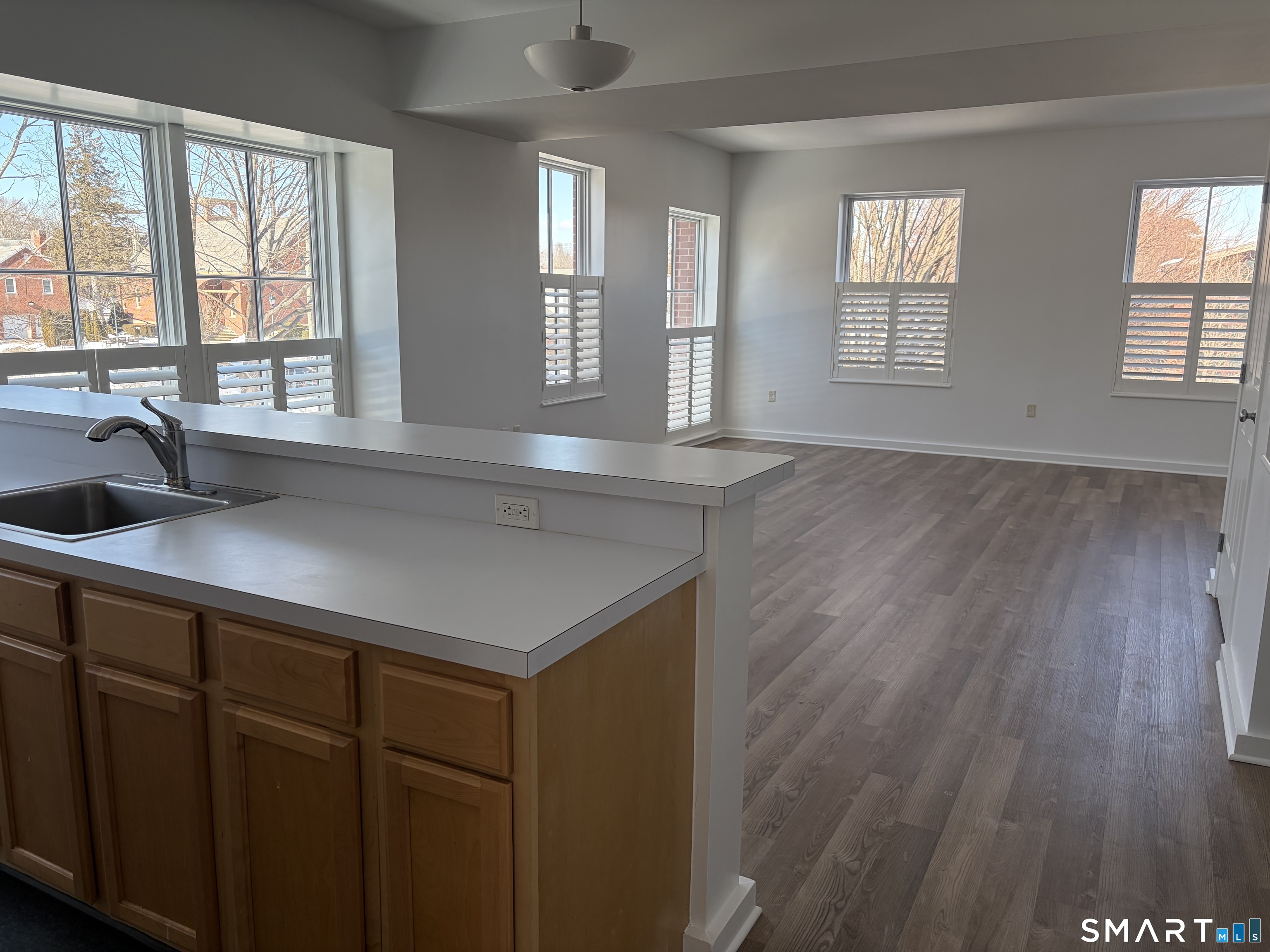 22 Durham Road, Unit A2 Madison, CT 06443 - Photo 8 of 22 a view of a kitchen with a sink a window and wooden floor
