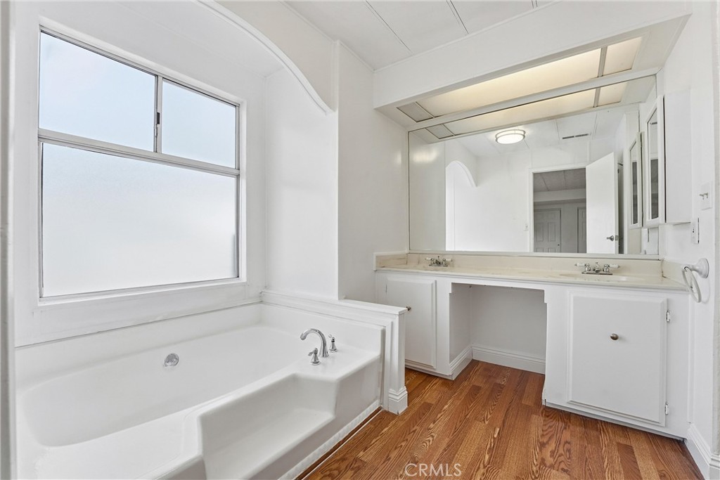 4901 Green River Road, Unit 140 Corona, CA 92878 - Photo 11 of 21 a bathroom with a tub sink and mirror