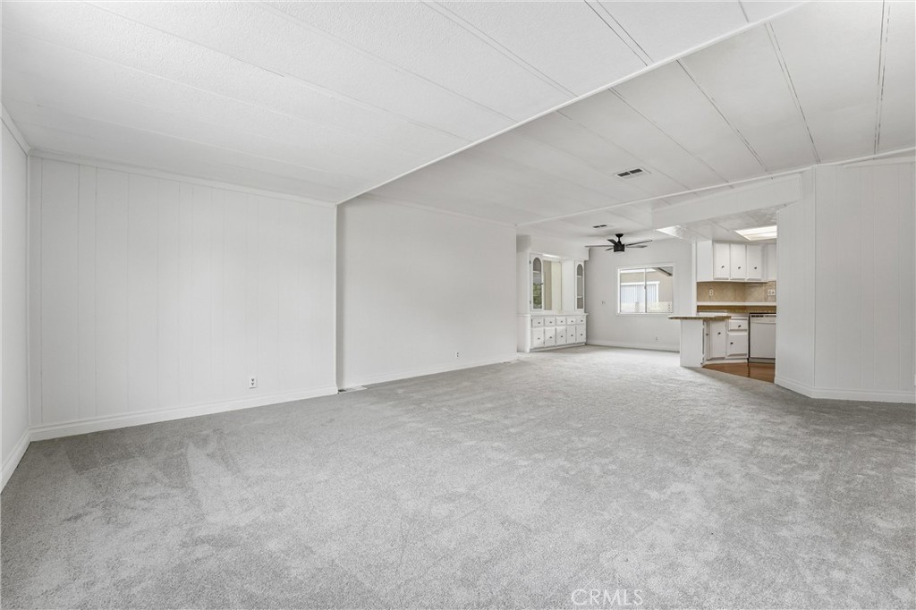 4901 Green River Road, Unit 140 Corona, CA 92878 - Photo 3 of 21 a view of a livingroom with furniture and a refrigerator